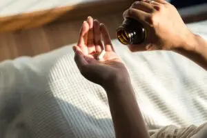 Woman hands with pills on the pill.