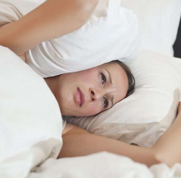 stress and hormones -- image of women looking stressed in a bed