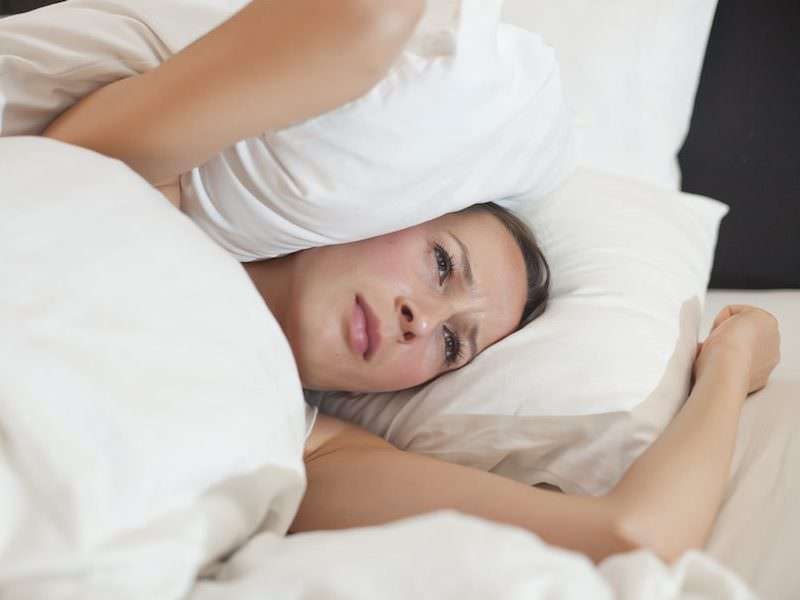 stress and hormones -- image of women looking stressed in a bed