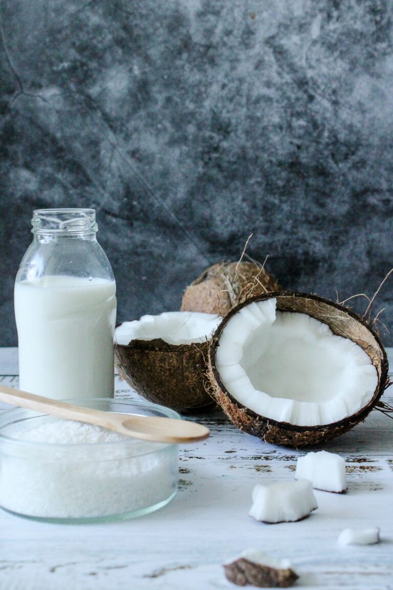 An image of a coconut and milk on a counter.