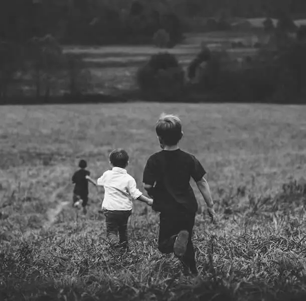 Natural Remedies for ADHD, black and white image of three boys running in a field