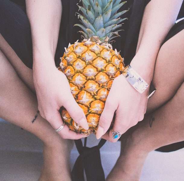 Can UTIs cause infertility, image of woman holding a pineapple