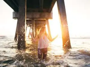 Natural Remedies to Reverse Infertility, Get Pregnant--image of a woman splashing in ocean