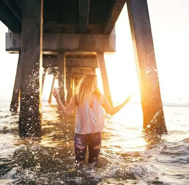 Natural Remedies to Reverse Infertility, Get Pregnant--image of a woman splashing in ocean